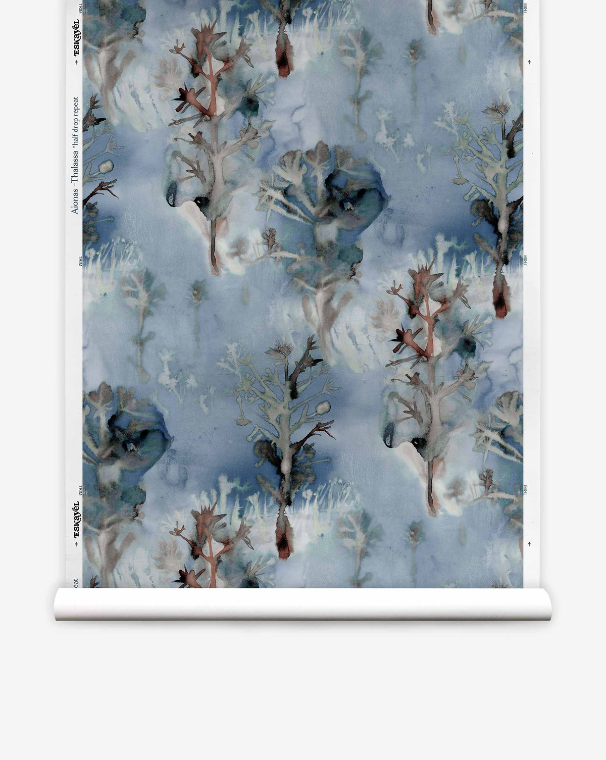 A roll of Aionas Silk Wallcovering in Thalassa, featuring a blue watercolor pattern of silhouetted trees and organic, nature-inspired shapes.
