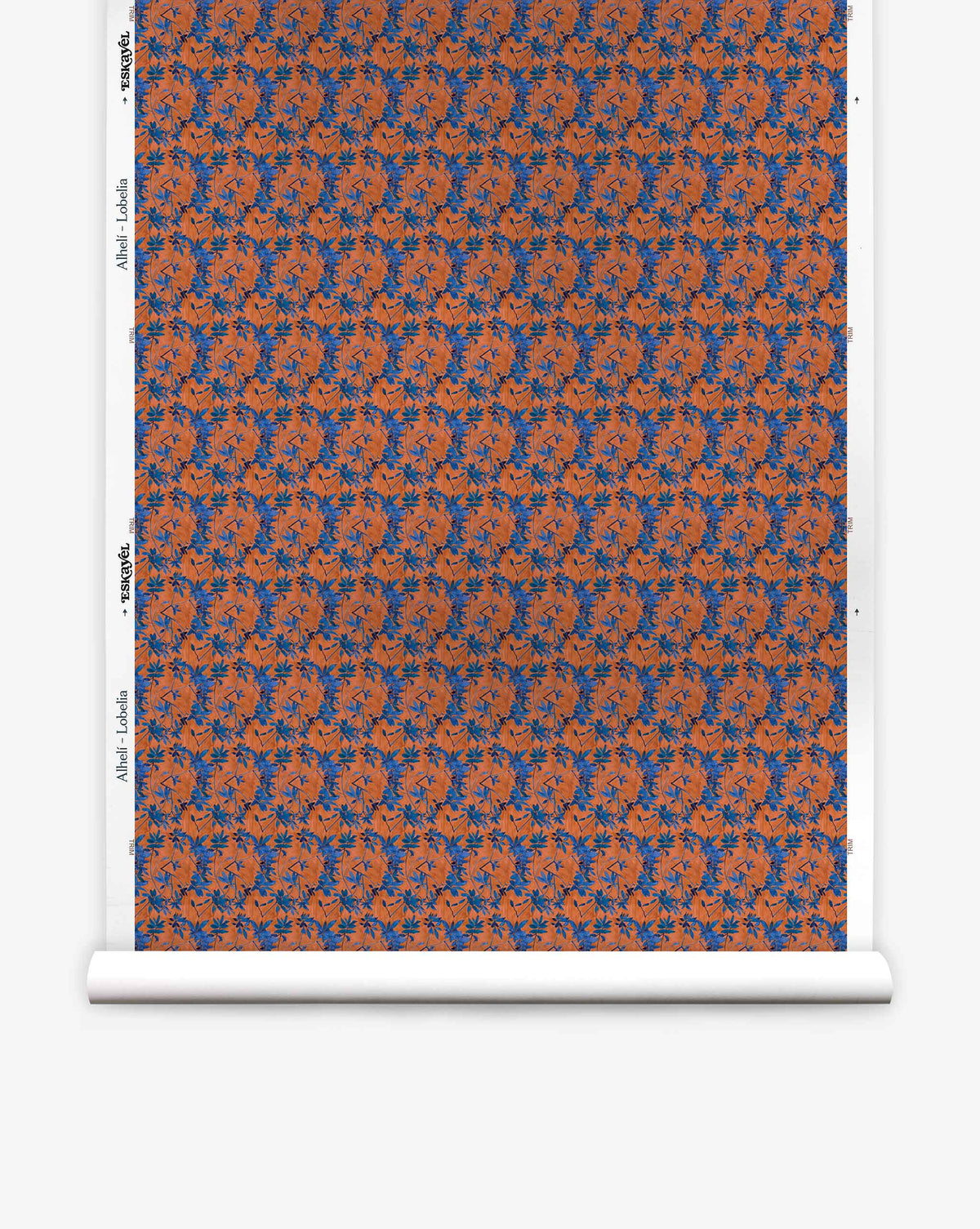 Alhelí Silk Wallcovering in Lobelia: an eco-friendly wallpaper roll featuring a dense, repeating pattern of blue flowers and foliage on a textured burnt orange background.