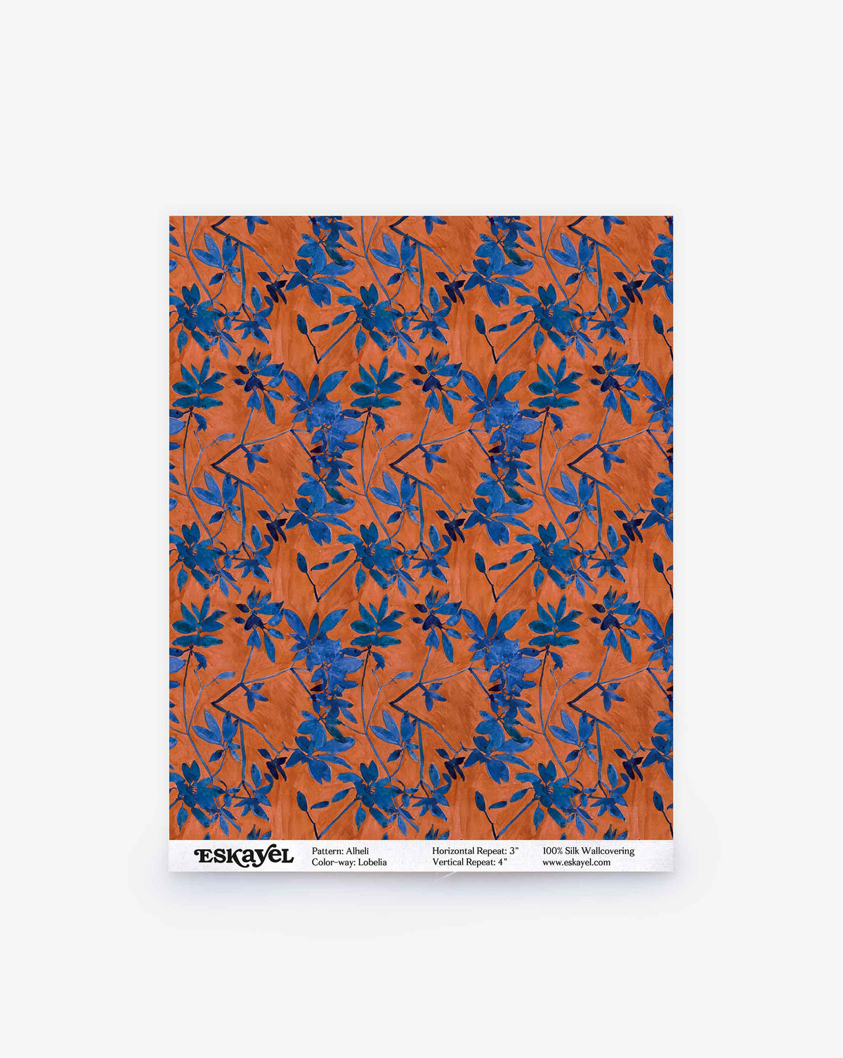 Alhelí Silk Wallcovering in Lobelia, featuring a pattern of blue flowers and foliage on a textured orange background.