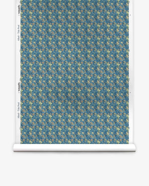 A roll of Alhelí Silk Wallcovering in Tide Pool, featuring a dense, repeating botanical pattern of cream-colored flowers and teal foliage on a dark blue background.