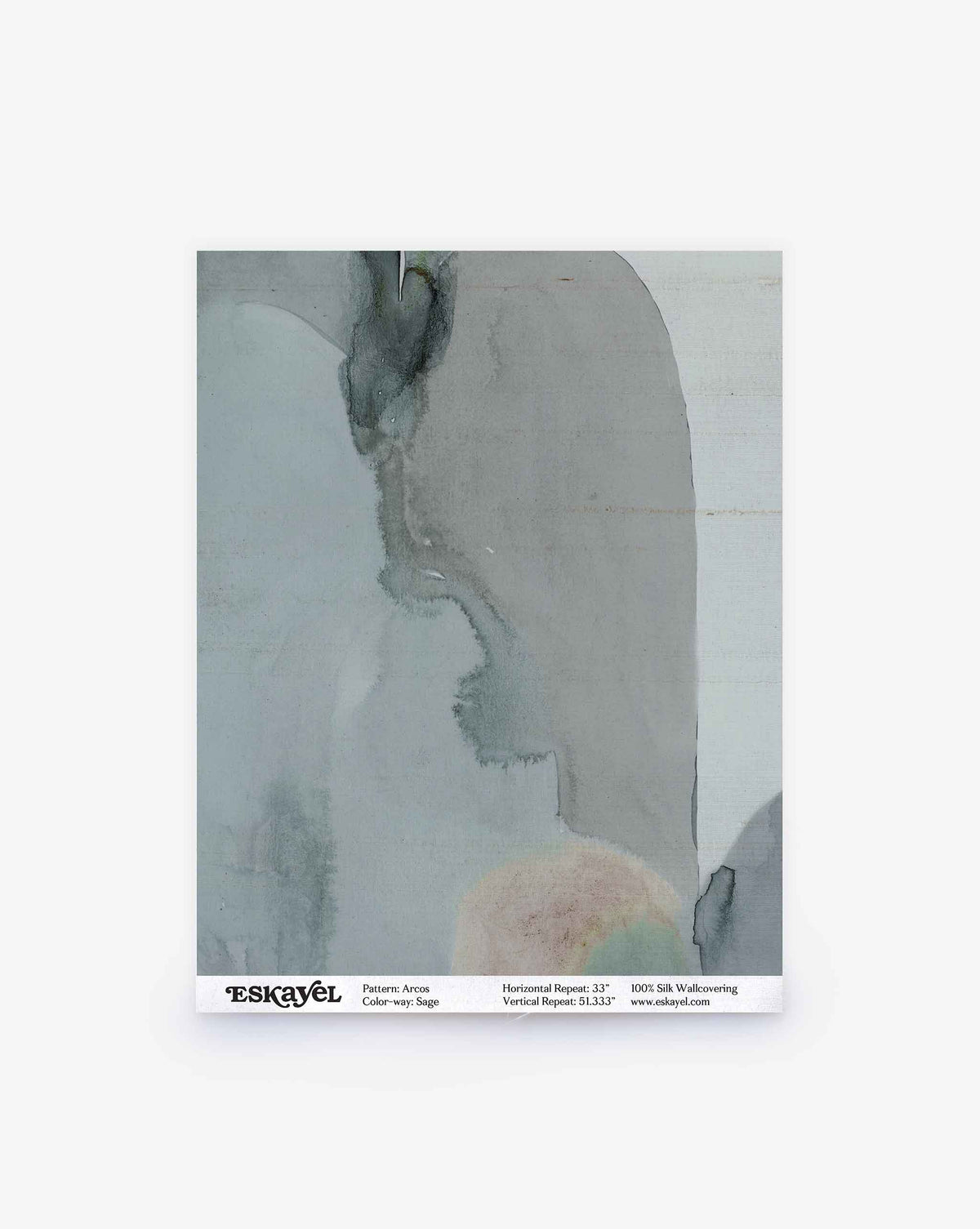 A sample swatch of wallpaper featuring abstract watercolor patterns in muted gray and beige tones is shown. The label below reads “ESKAYEL — Arcos Silk Sample||Sage,” displaying product and pattern details to make ordering a sample for your space quick and easy.