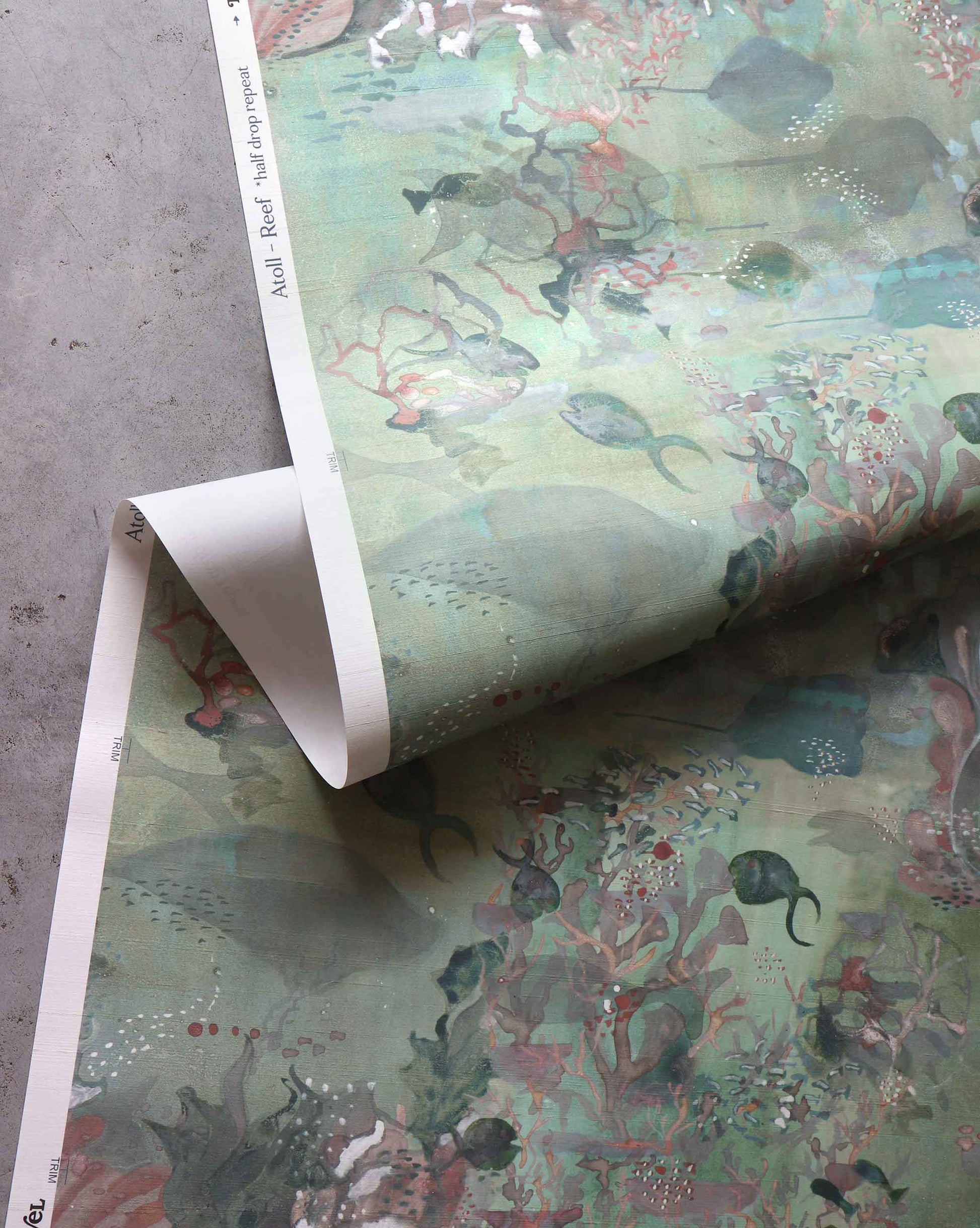 A close up detailed shot of Eskayel’s Atoll wallpaper in the colorway Reef with its green hues.
