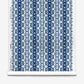 A roll of Bali Stripe Silk Wallcovering in Indigo Ikat, featuring a vertical indigo and white stripe pattern.