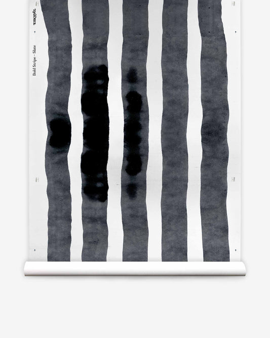 Bold Stripe Silk Wallcovering in Slate, a luxury silk wallpaper roll featuring vertical, watercolor-style dark gray stripes on a white background.