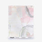 A swatch of Canopy Silk Sample in Cameo featuring an abstract pattern of soft pink and grey brushstrokes on an off-white background; order a sample to see the design in your space.