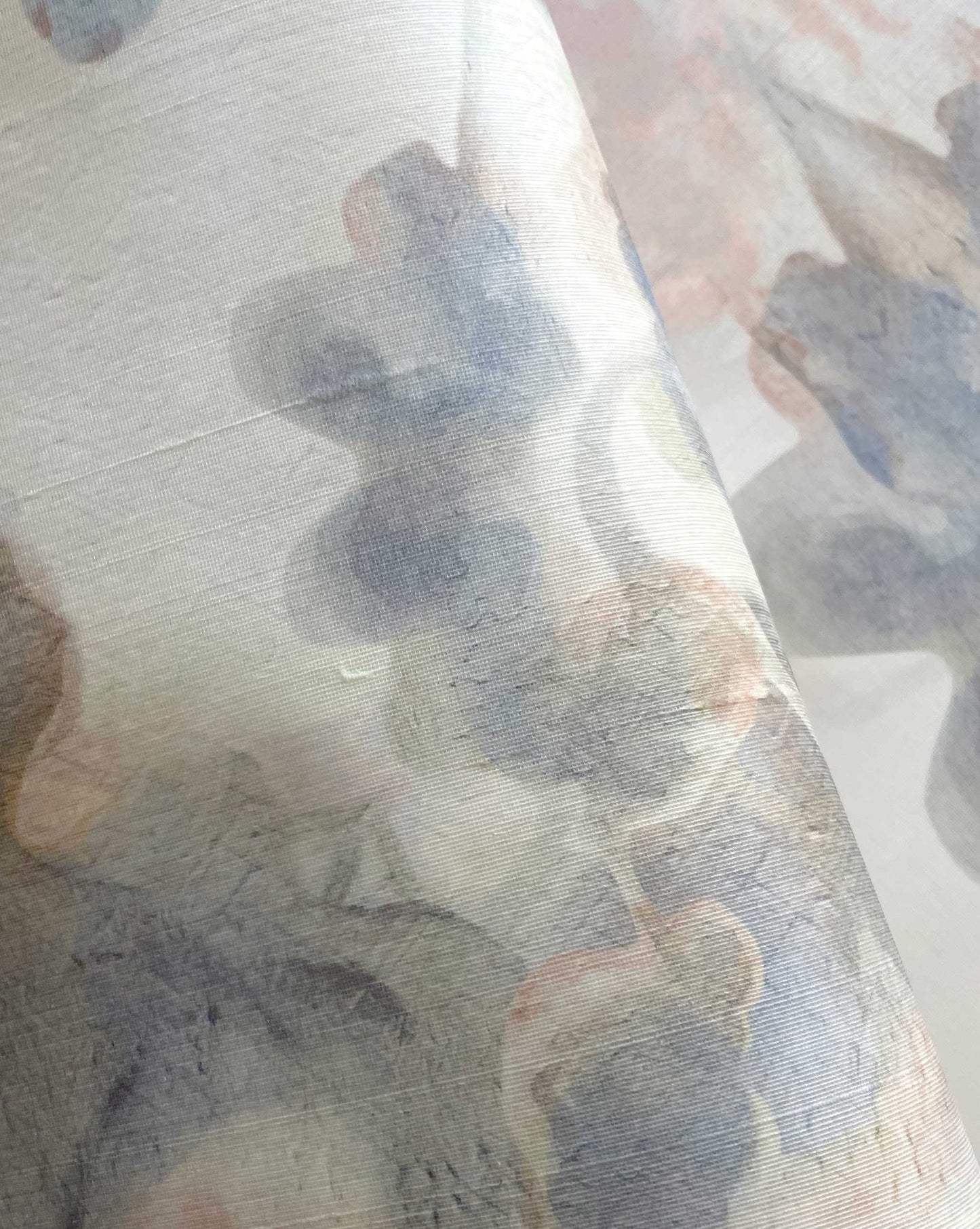 Close-up of Clemente Silk Wallcovering||Sol, featuring semi-transparent silk with a muted, abstract floral pattern in soft pastel tones, inspired by the relaxed elegance of Southern California design.
