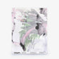 Cocos Silk Sample||Cay features abstract watercolor brushstrokes in soft pink, green, and black on a pristine white background. Displayed flat with text at the bottom, this modern piece adds refined elegance to any space—order a sample today to experience the quality and artistry of Cocos Silk Sample||Cay firsthand.
