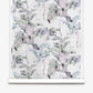 Introducing the Cocos Silk Wallcovering||Cay: a roll of elegant wallpaper showcasing a repeating watercolor design with anteaters and lush foliage, accented by subtle palm tree motifs in soft pastel tones on a crisp white background.
