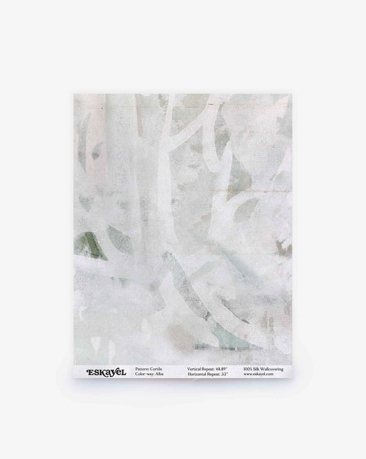 A sample of pale, abstract-patterned wallpaper with faded white and gray tones, reminiscent of a delicate watercolor design, labeled “Cortile Silk Wallcovering||Alba” at the bottom.
