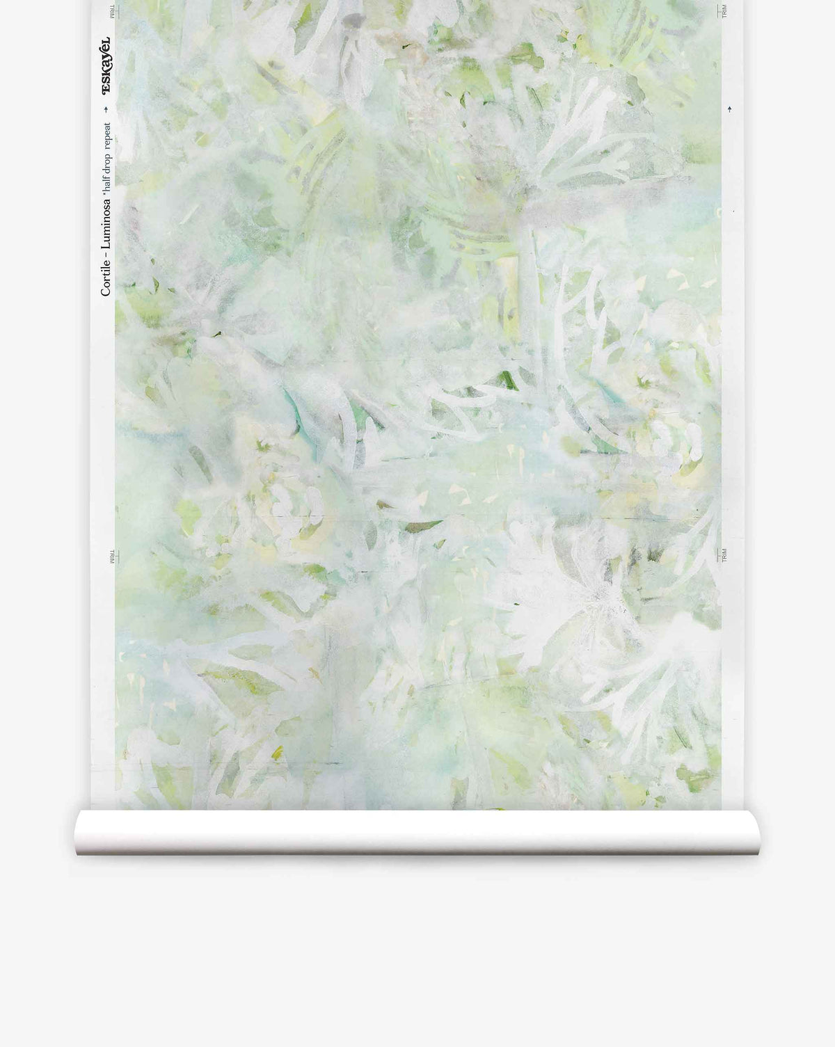 A roll of Cortile Silk Wallcovering||Luminosa, featuring a pale green and white abstract floral pattern inspired by an Italianate garden, is partially unrolled against a white background.