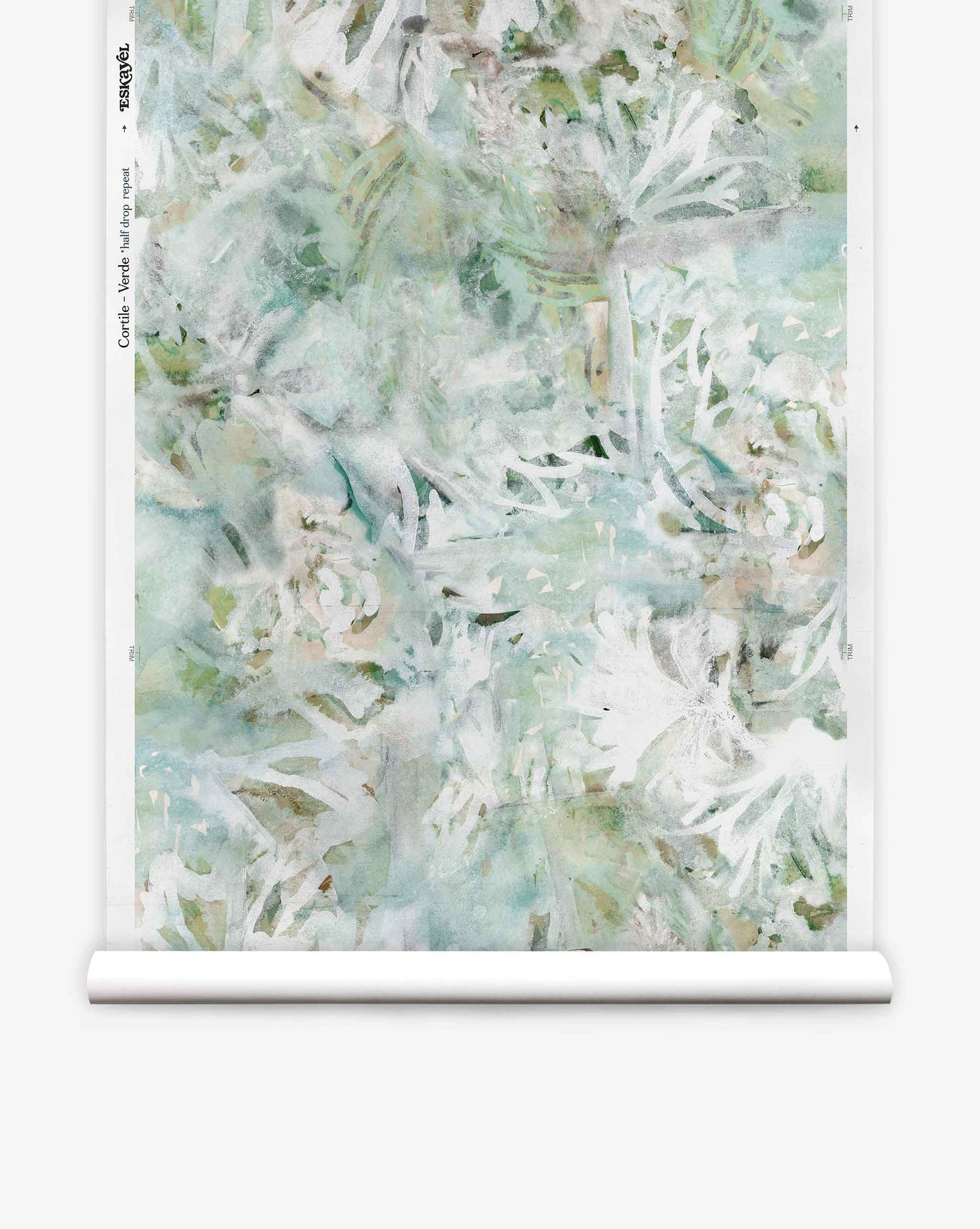 A roll of Cortile Silk Wallcovering||Verde features a watercolor pattern with abstract white tropical leaves and light green, blue, and beige backgrounds, evoking the serene beauty of an Italianate garden.