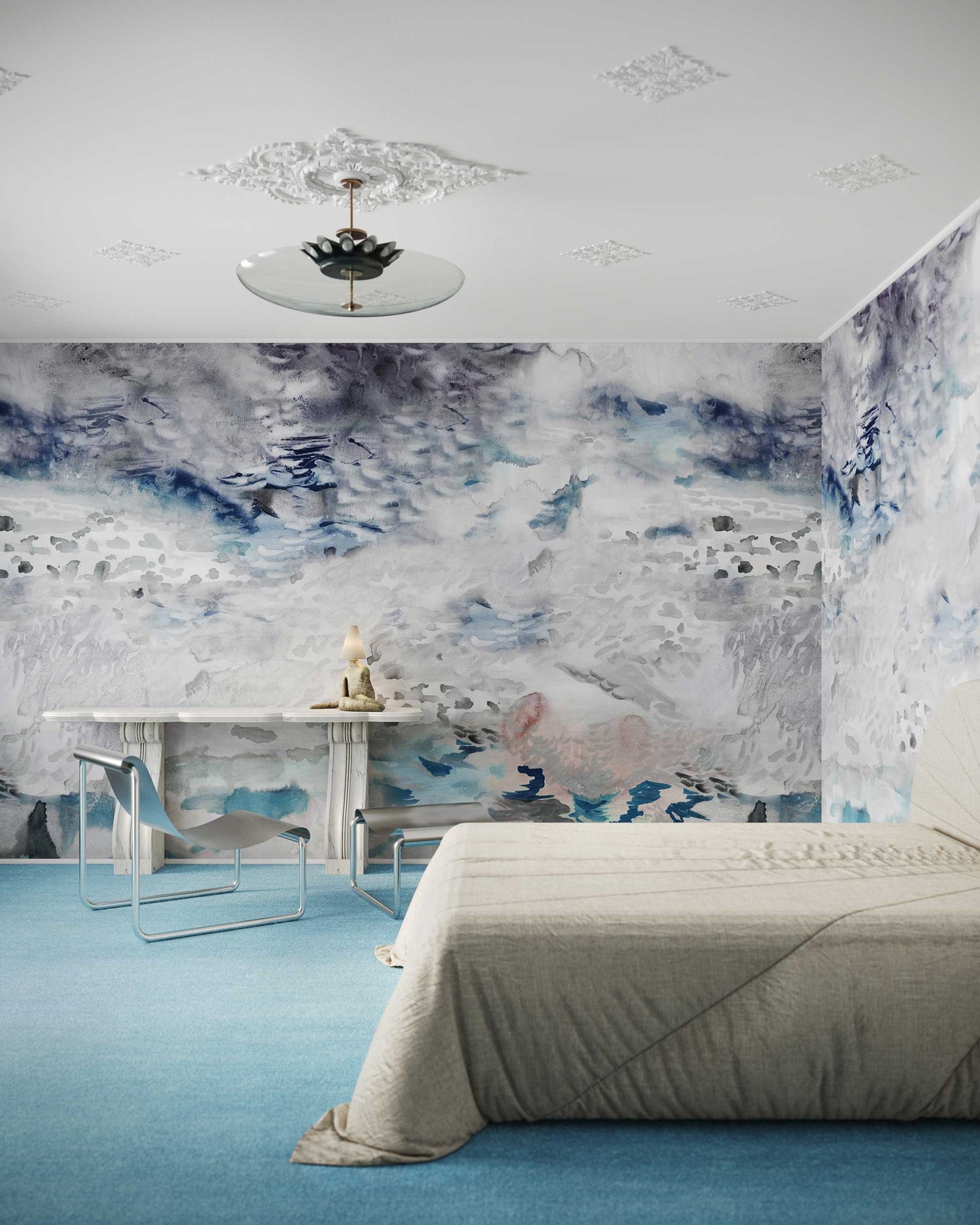 Bedroom with light beige bed, blue carpet, and an Empyrean Silk Mural||Air wallcovering featuring an abstract cloud theme. The room features a small table with a chair and a ceiling light fixture, creating an ethereal atmosphere.