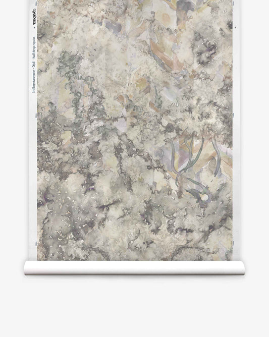 A roll of Inflorescence Silk Wallcovering||Sol features a textured, marble-like pattern in muted gray, beige, and green on a white background.