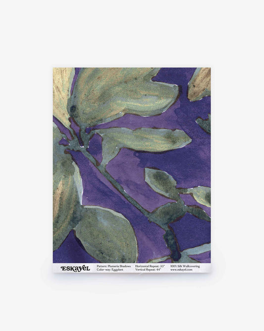 Plumeria Shadows Silk Wallcovering in Eggplant features an abstract watercolor design with green leaves and branches set against a rich eggplant background. Pattern details and the Eskayel brand name are displayed at the bottom, making it an ideal choice for anyone seeking a unique tropical or elegant silk wallpaper design.