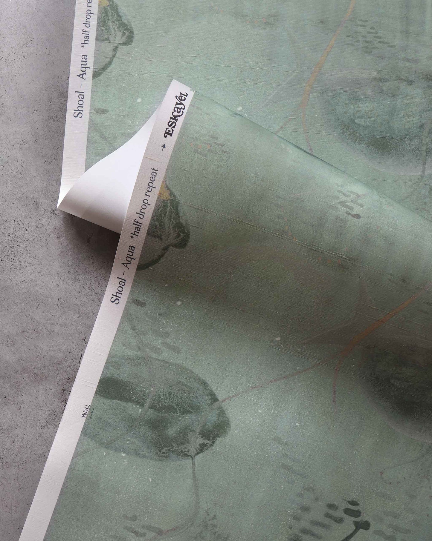 A detailed shot of Eskayel’s Shoal wallpaper in the colorway Aqua with its green hues.