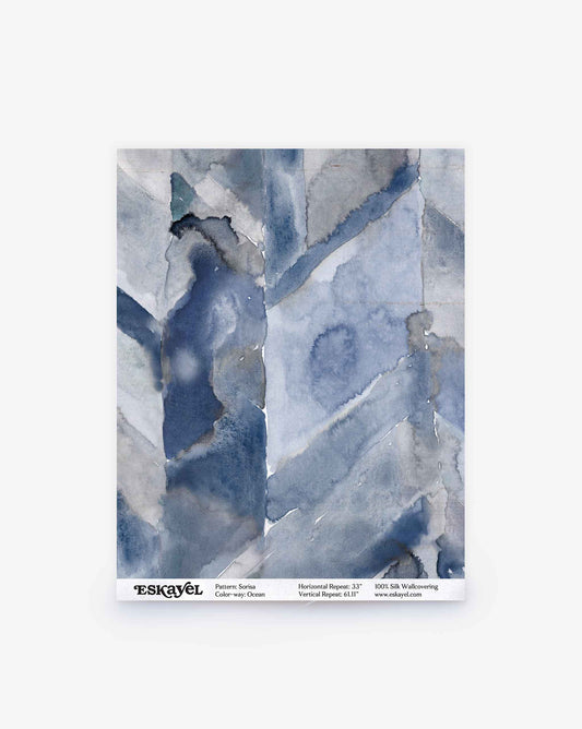 A sample of Sorisa Silk Wallcovering||Ocean features abstract, watercolor-style blue and gray patterns, labeled “Pattern: Sarka,” “Color: Stormy Ocean.”.