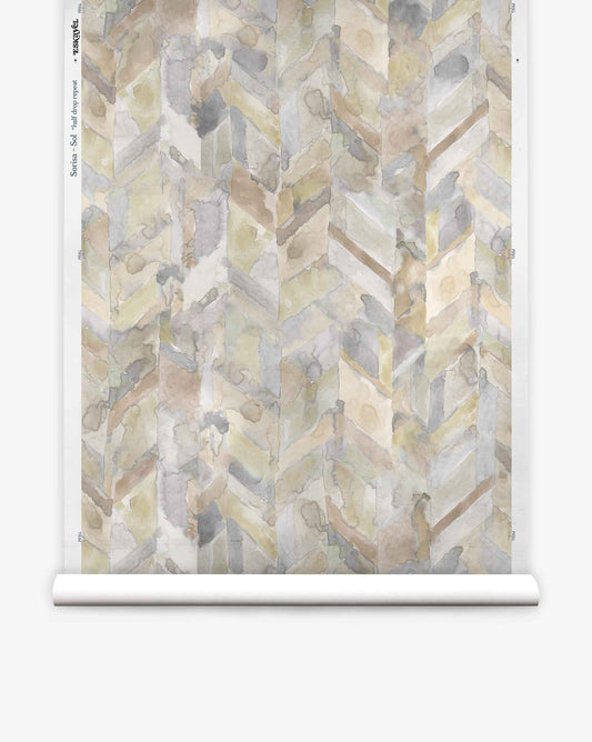 A roll of Sorisa Silk Wallcovering||Sol features a soft, abstract herringbone design in muted beige, gray, and tan watercolor shades.