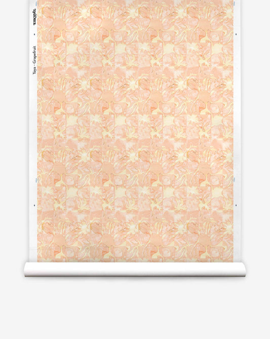 A roll of Yaya Silk Wallcovering in Grapefruit, featuring an abstract, tonal pattern of layered coral and cream shapes.