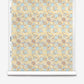 Roll of Yaya Silk Wallcovering in Husk, featuring a paper-backed silk design with a repeating geometric pattern of beige, brown, and light blue shapes.