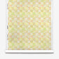 Yaya Silk Wallcovering in Limeade featuring a repeating checkered pattern of soft yellow, peach, and green abstract floral aquarelle designs.