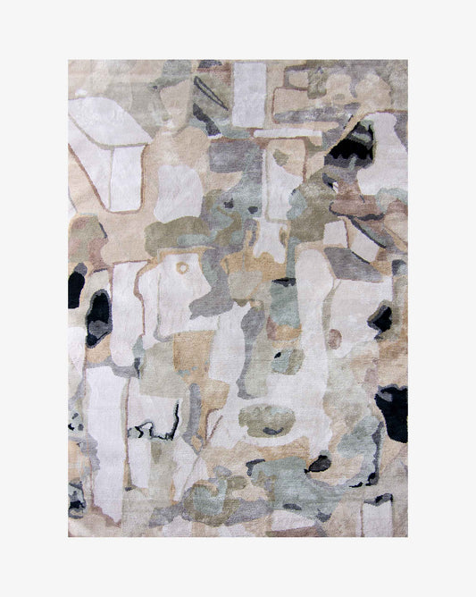 A Medina Hand Knotted Rug Blanca with a lot of different abstract painterly shapes that recall the geometry of Marrakesh roofs in a color pallate of tans, greys, and black | Eskayel