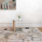 A hand-knotted Medina Blanca rug in a room showcasing the influence of Medina and Marrakesh roofs, with a painting on the wall | Eskayel