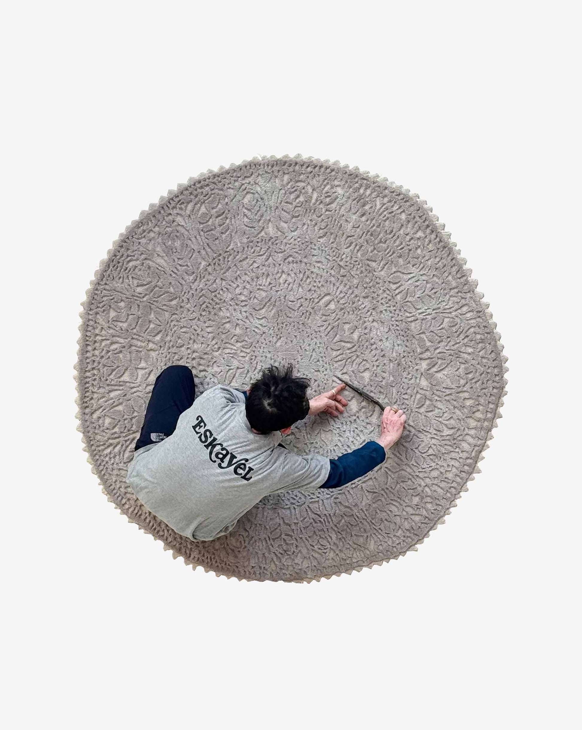 Nonna’s Lace in Blanca is a round, neutral rug with a low-pile wool background and high-pile lace pattern in silk and wool.