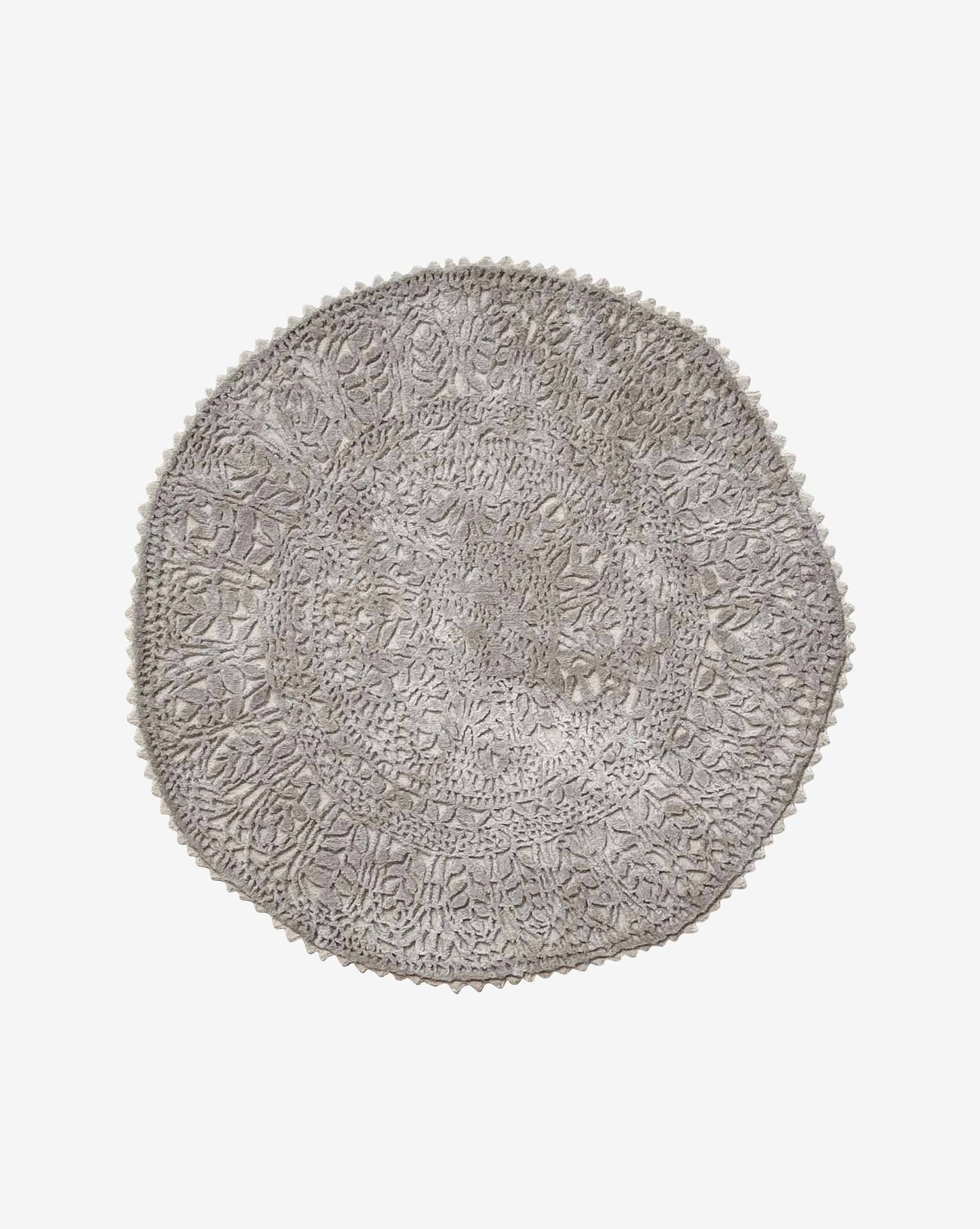 Hand-cut and hand-finished, a Nonna’s Lace rug in the Blanca colorway is a round design in creamy beige silk and wool.