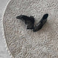 Black high-heeled shoes on our Nonna's Lace round rug in the colorway neutral.