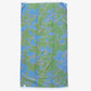 The reverse side of the Eskayel x Meleau Plumeria Shadows beach towel displays apple green, teal, and soft pink. 