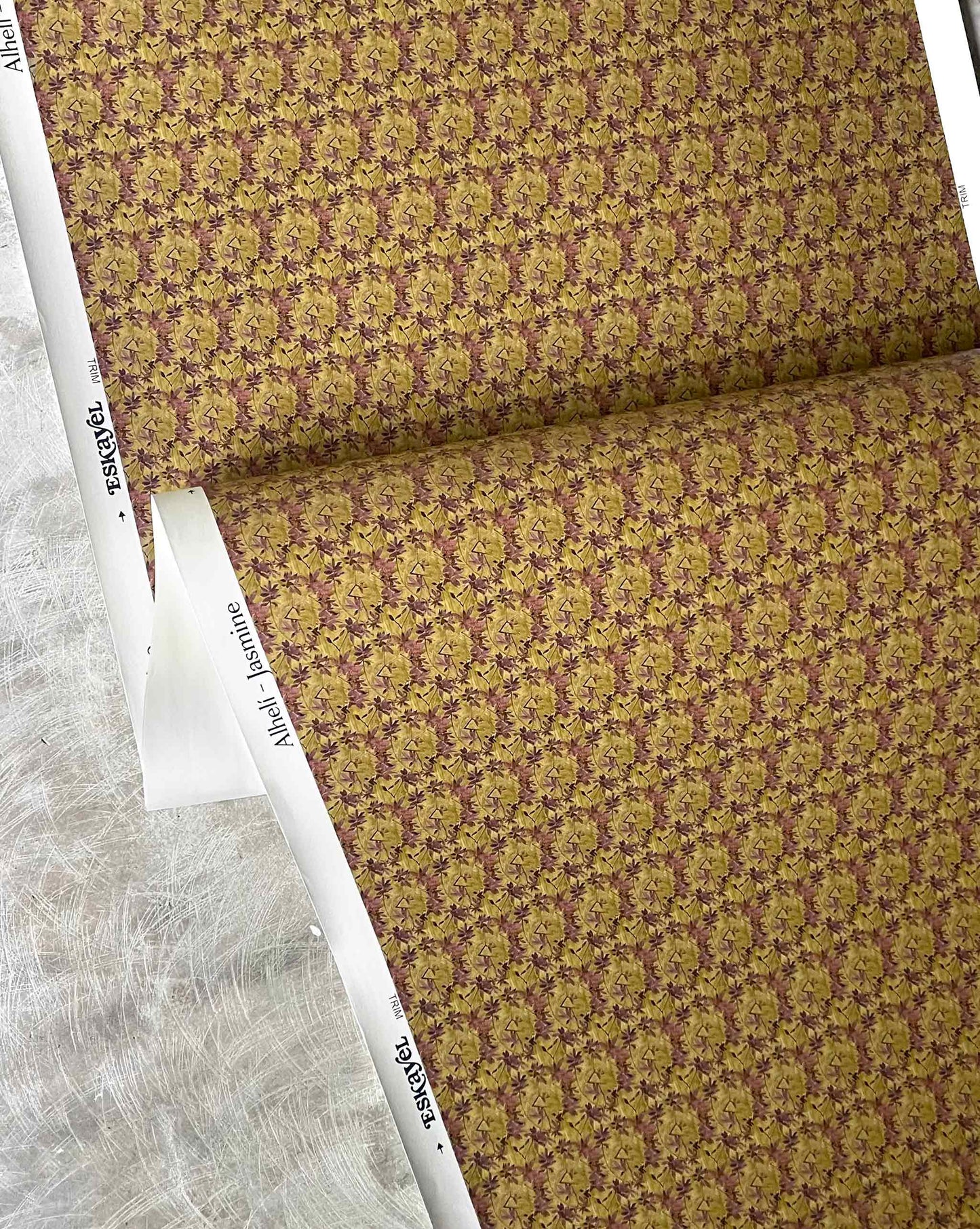 A close-up of Eskayel’s Alhelí, a tiny repeating wallpaper pattern in the green-based colorway Jasmine.