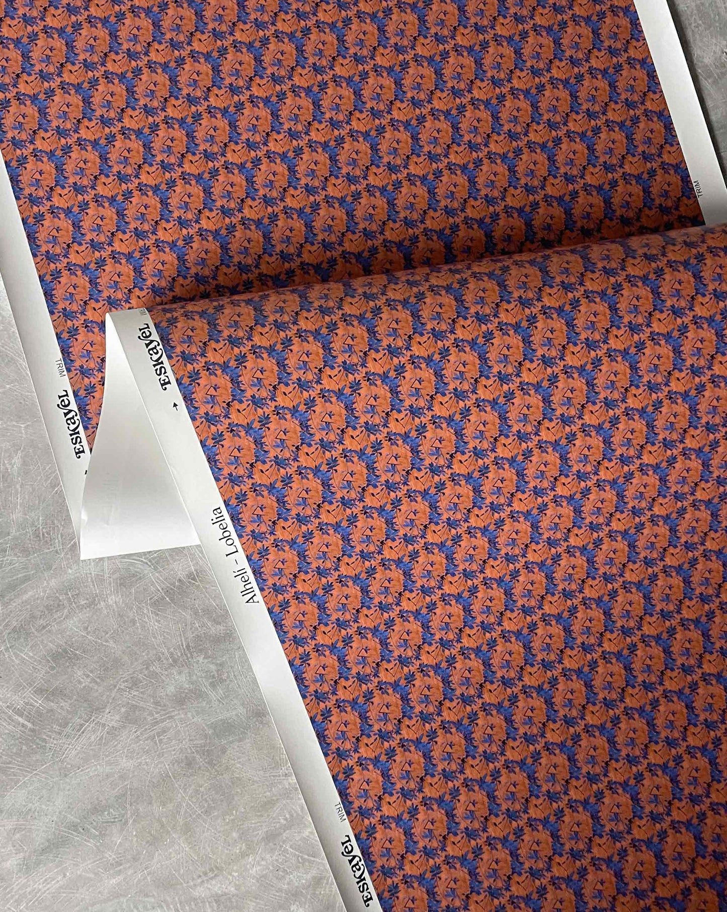 A close-up of Eskayel’s Alhelí wallpaper, a tiny repeating pattern inspired by tropical living in the red-based Lobelia colorway.