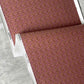 Alhelí wallpaper flowy fold, a tiny repeating pattern inspired by tropical living, in the brown-based colorway Rubra | Eskayel