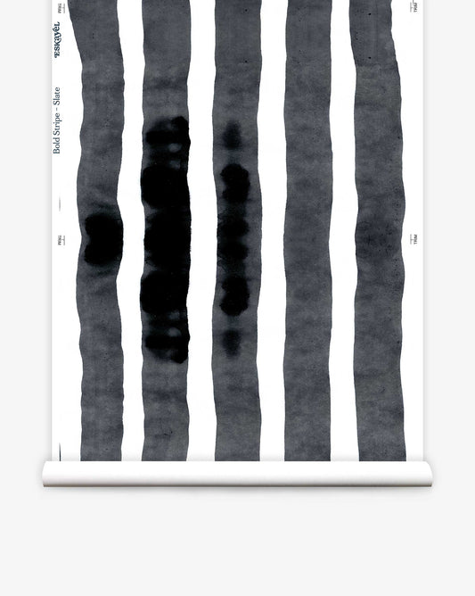 The Bold Stripe Wallpaper in Slate features vertical black stripes on a white background reminiscent of ink brush strokes, capturing the essence of Eskayel's Stripes Collection.