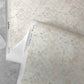 A neutral floral micro-printed wallpaper in the Crochet lace pattern in the colorway ricotta.
