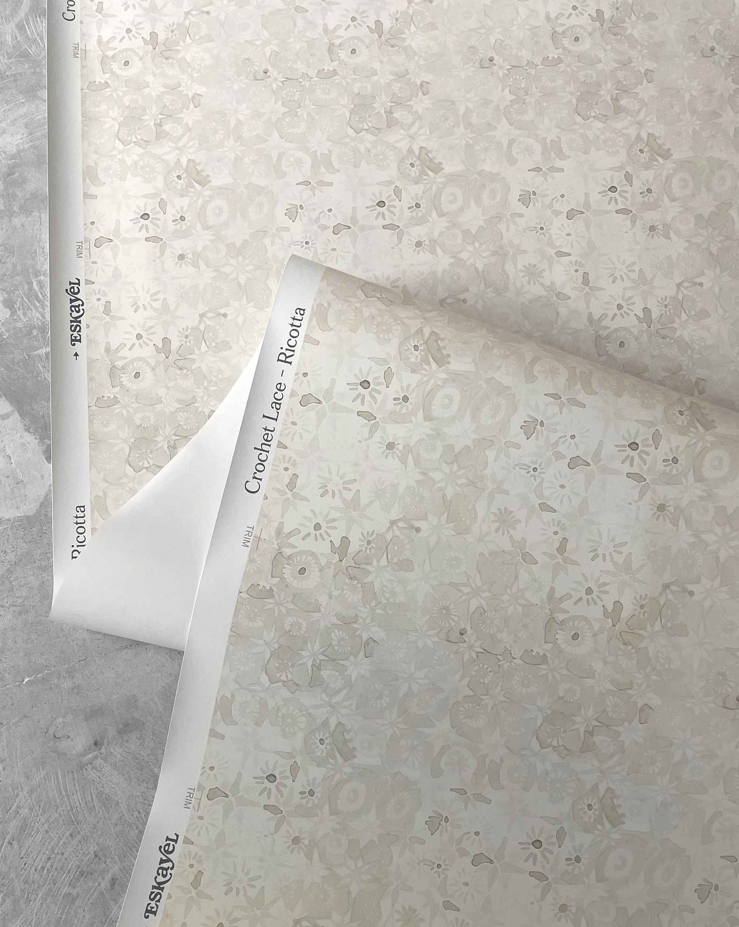 A neutral floral micro-printed wallpaper in the Crochet lace pattern in the colorway ricotta.
