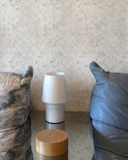 A white lampshade on a mirrored side table against Eskayel's crochet lace pattern in the colorway ricotta.
