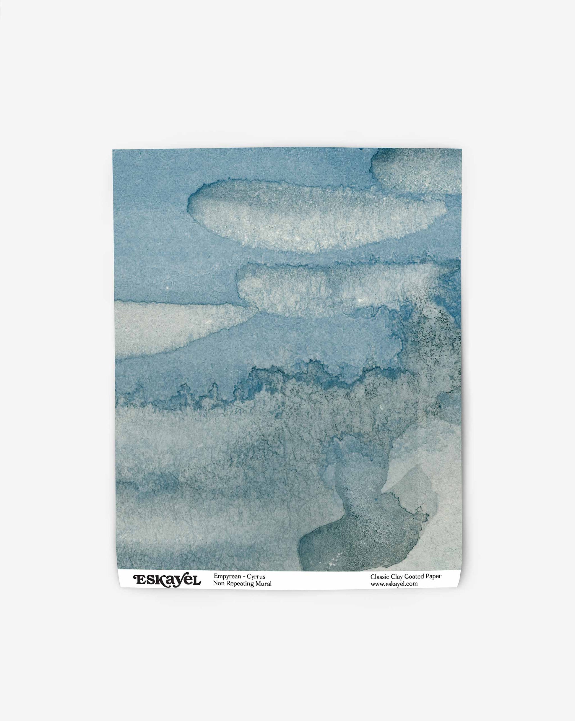 Empyrean mural wallpaper swatch by Eskayel is based on a watercolor collage of skyscapes and sunsets. In Cyrrus, the palette centers on navy blue.