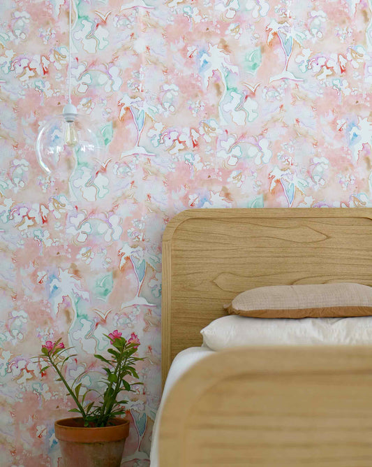 Eskayel's kokomo wallpaper in the colorway Punch with its primary color being red with hints of bright colors throughout installed in a bedroom.