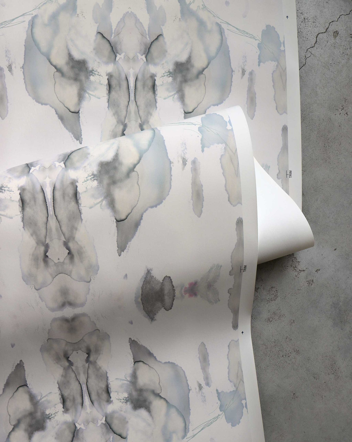 A detail shot of Madagascar Wallpaper in the colorway Mist which features a blue and beige pattern.