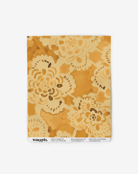 A swatch of the Margherita wallpaper pattern in Limoncello offers a warm watercolor palette of yellow tones.