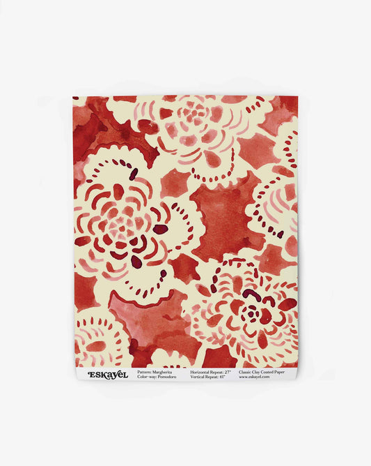 Inspired by handmade lace, a wallpaper swatch of Margherita in Pomodoro displays a warm red colorway. 
