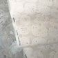 A Neutral floral lace wallpaper in Eskayel's Margherita Ricotta.