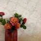 Vase of flowers against a Eskayel's Margherita wallpaper in the ricotta colorway.