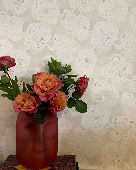 Vase of flowers against a Eskayel's Margherita wallpaper in the ricotta colorway.