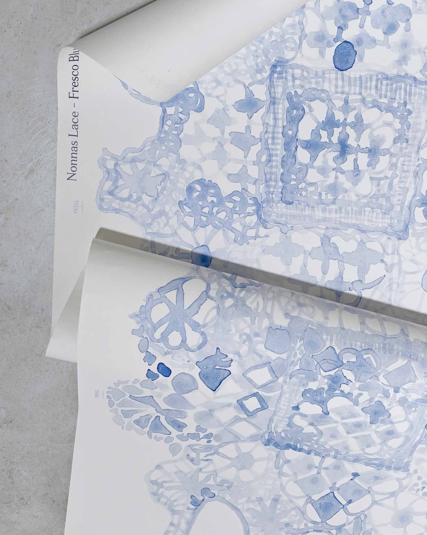 Based on an heirloom lace pattern, Nonna’s Lace in Fresco Blue is a large-scale non-repeating wallpaper in blue tones.