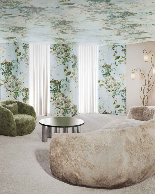 Shown installed on a wall, Eskayel’s Pétalos wallpaper in Pool is a bright multicolor colorway with a turquoise background.