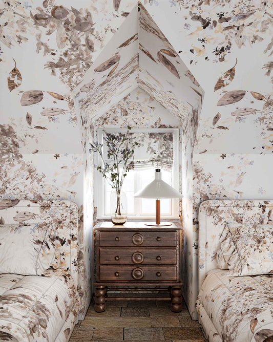 Shown installed on a bedroom wall, Eskayel’s Pétalos wallpaper in Sand Dollar is a neutral colorway of pearl, cream, and oyster tones.