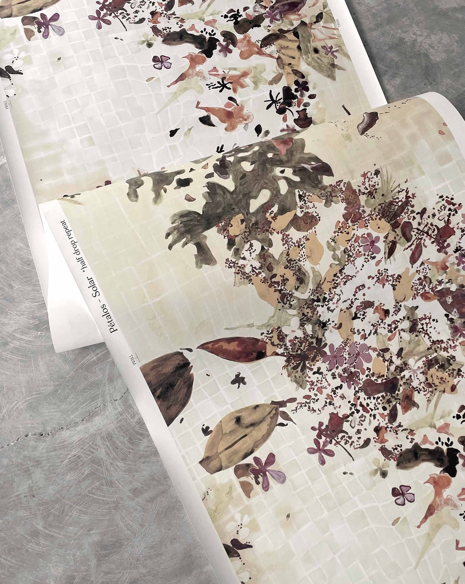 Shown flowing off a roll, Pétalos wallpaper by Eskayel in Solar is a warm colorway of earthy tones.