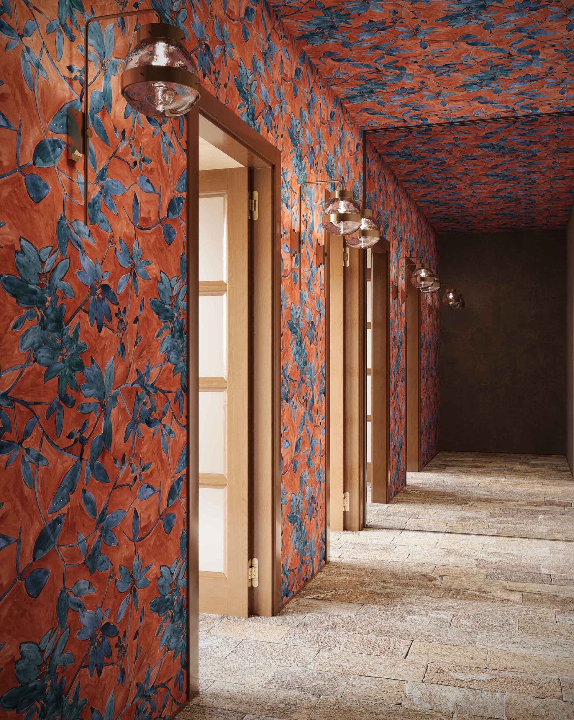 Plumeria Shadows Wallpaper Hibiscus — hand-painted tropical branches and leaves casting sharp shadows onto a stone patio in the midday sun form the basis of this pattern. Installed in a hallway in Hibiscus, a colorway of rich red and deep blue tones | Eskayel